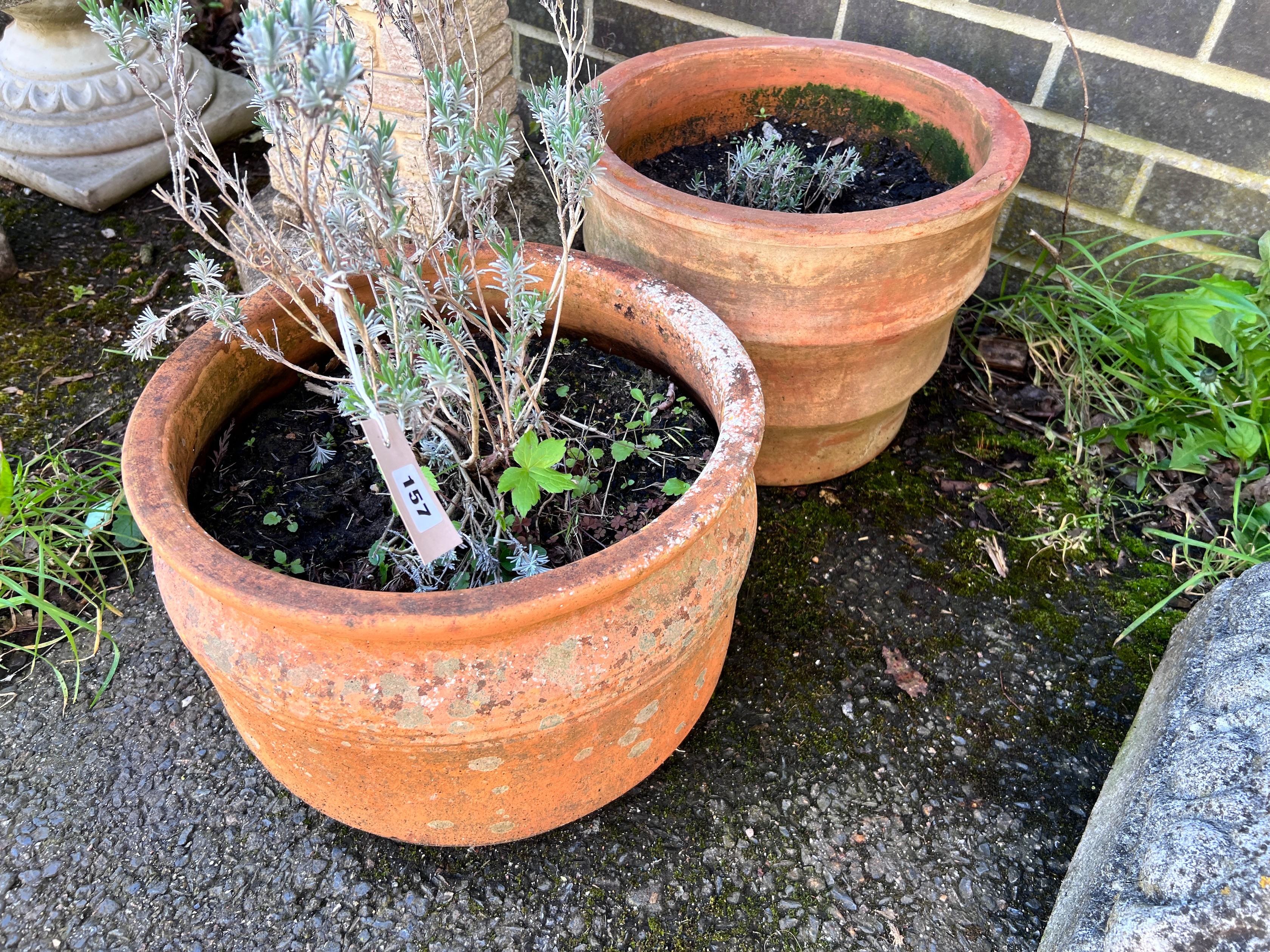 Two circular terracotta planters, larger height 30cm